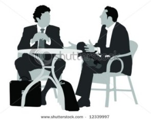 Gentlemen at coffee table.
