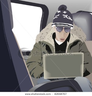 Young man using computer on the train